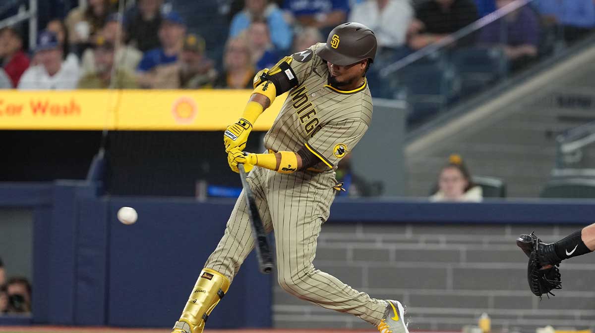 May 20, 2025; Toronto, Ontario, CAN; San Diego Padres first baseman Luis Arraez (4) hits a double against the Toronto Blue Jays during the first inning at Rogers Centre.