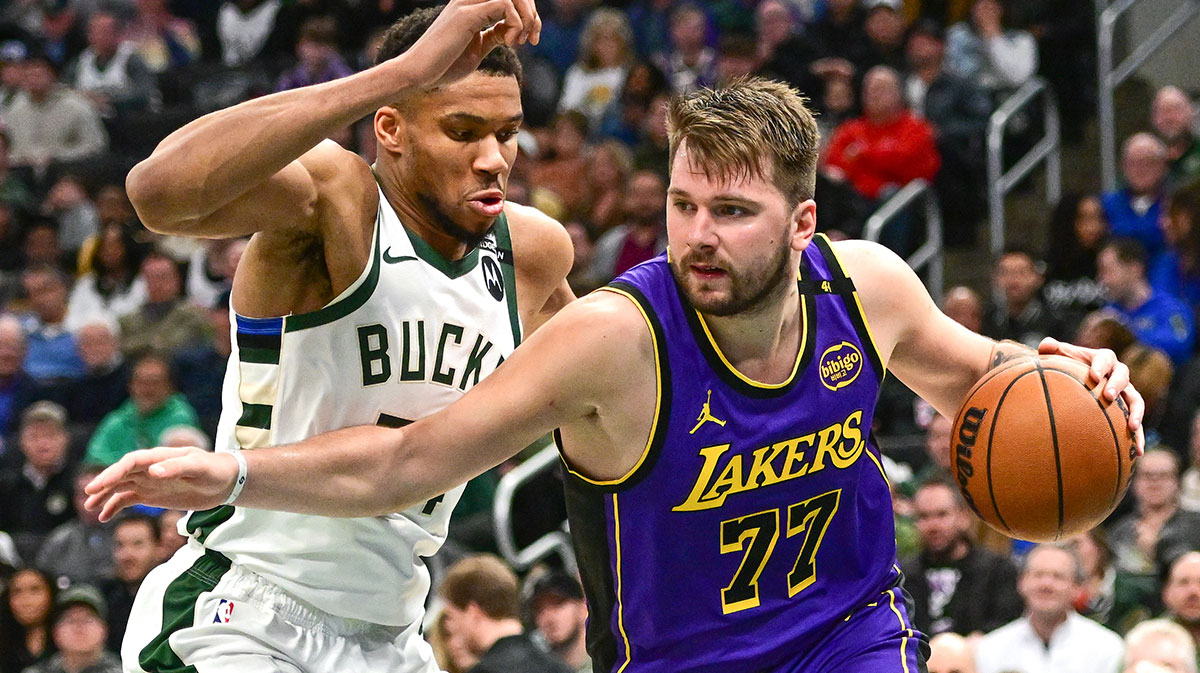 Los Angeles Lakers guard Luka Doncic (77) drives to the basket against Milwaukee Bucks forward Giannis Antetokounmpo (34) in the third quarter at Fiserv Forum.