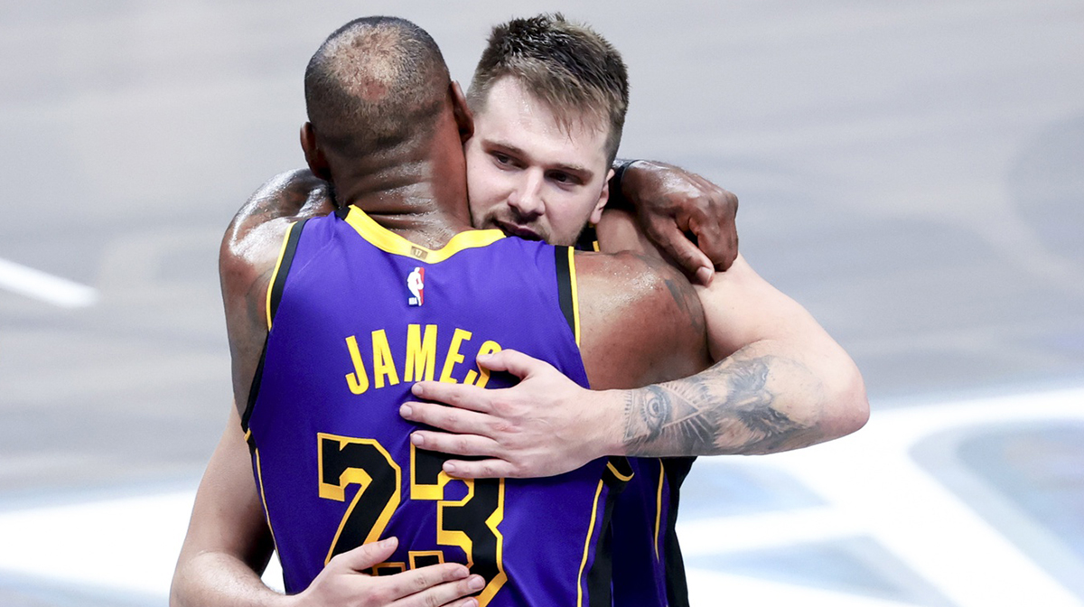 Los Angeles Lakers guard Luka Doncic (77) celebrates with Los Angeles Lakers forward LeBron James (23) during the fourth quarter against the Dallas Mavericks at American Airlines Center.