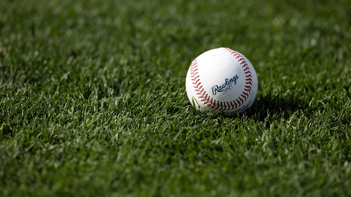A Major League Baseball sits on the turf before a game between the Athletics and San Francisco Giants the at Oracle Park.