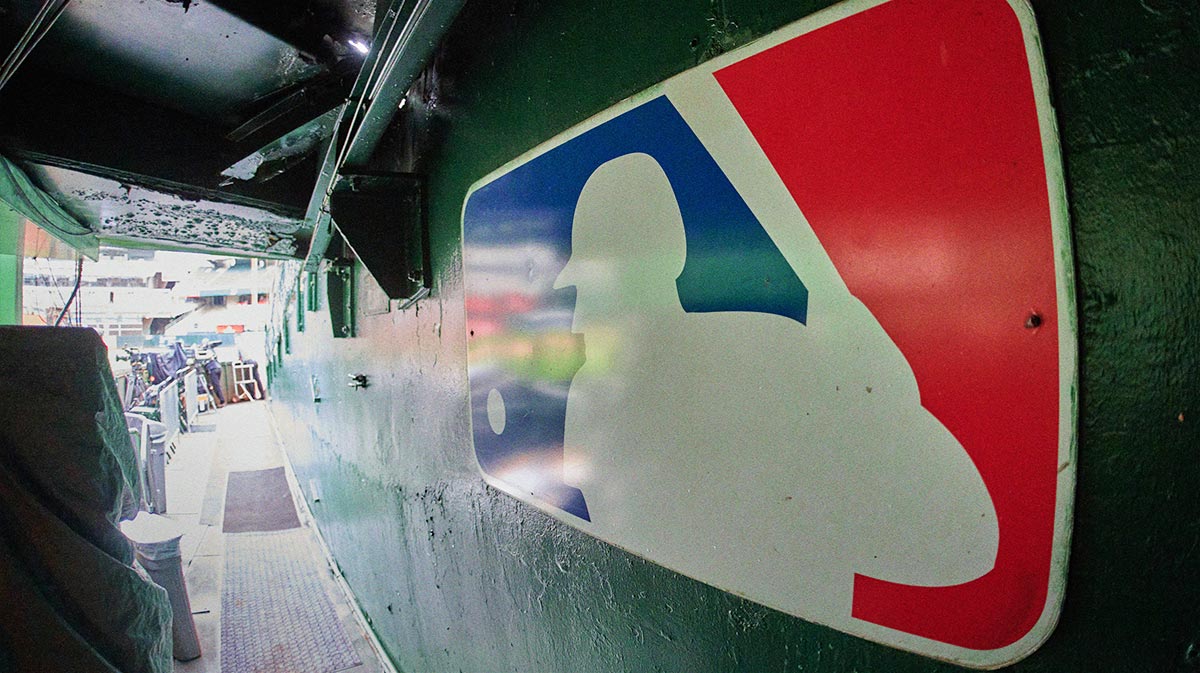 The major league baseball logo is seen on signage near the player's entrance to the field at Oakland-Alameda County Coliseum before the game between the Oakland Athletics and the Milwaukee Brewers.