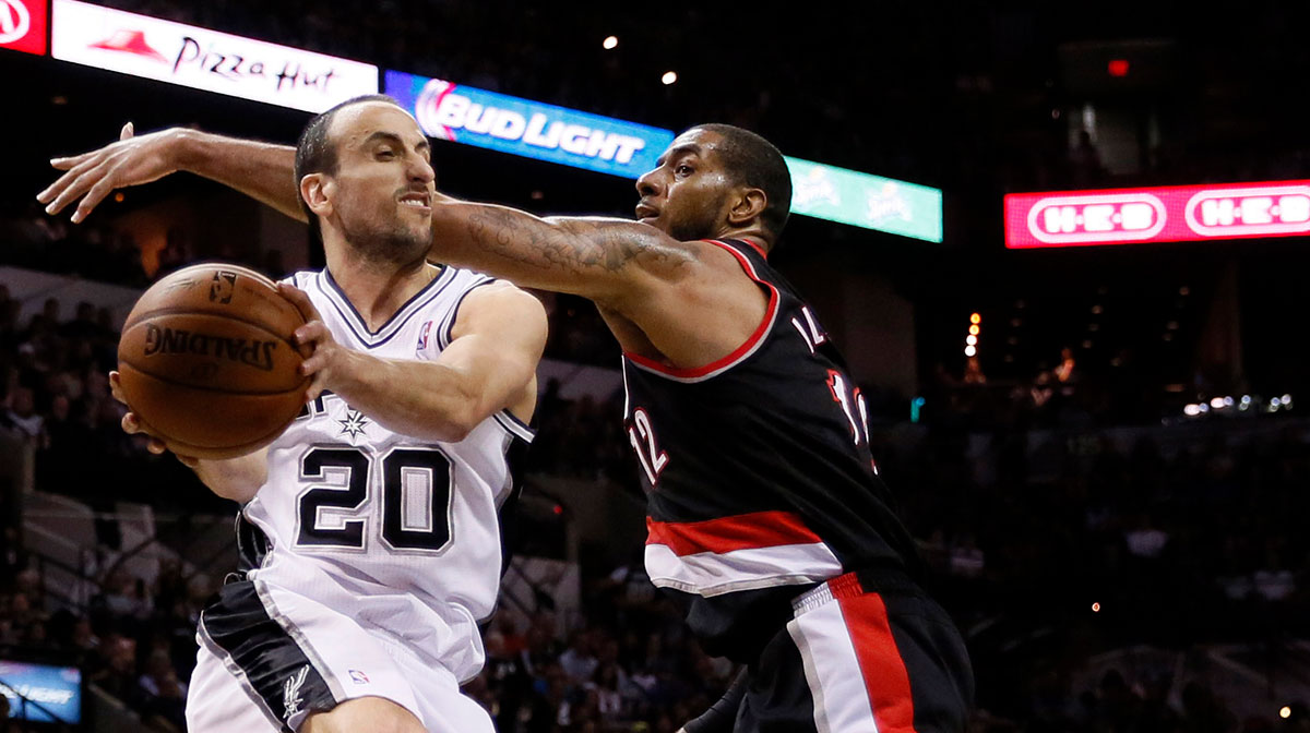 San Antonio Spurs guard Manu Ginobili (20) passes the ball under the basket against Portland Trail Blazers forward LaMarcus Aldridge (right) in game one of the second round of the 2014 NBA Playoffs at AT&T Center. The Spurs won 116-92.
