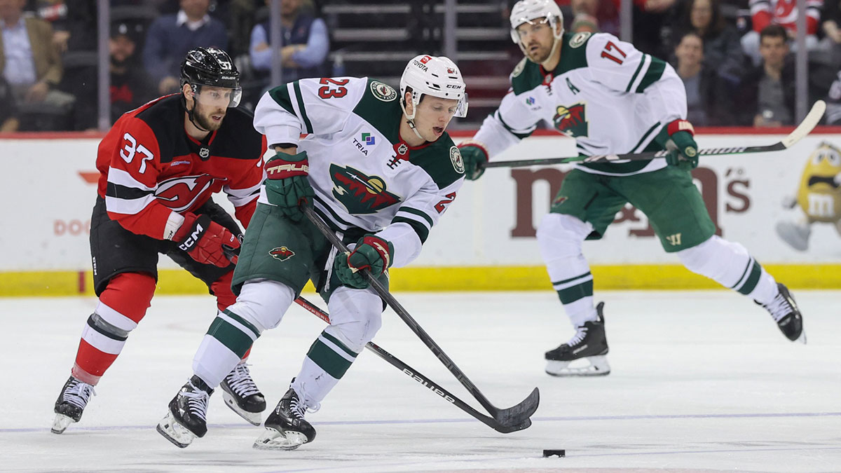 Minnesota Wild center Marco Rossi (23) skates with the puck as New Jersey Devils center Justin Dowling (37) defends during the first period at Prudential Center.