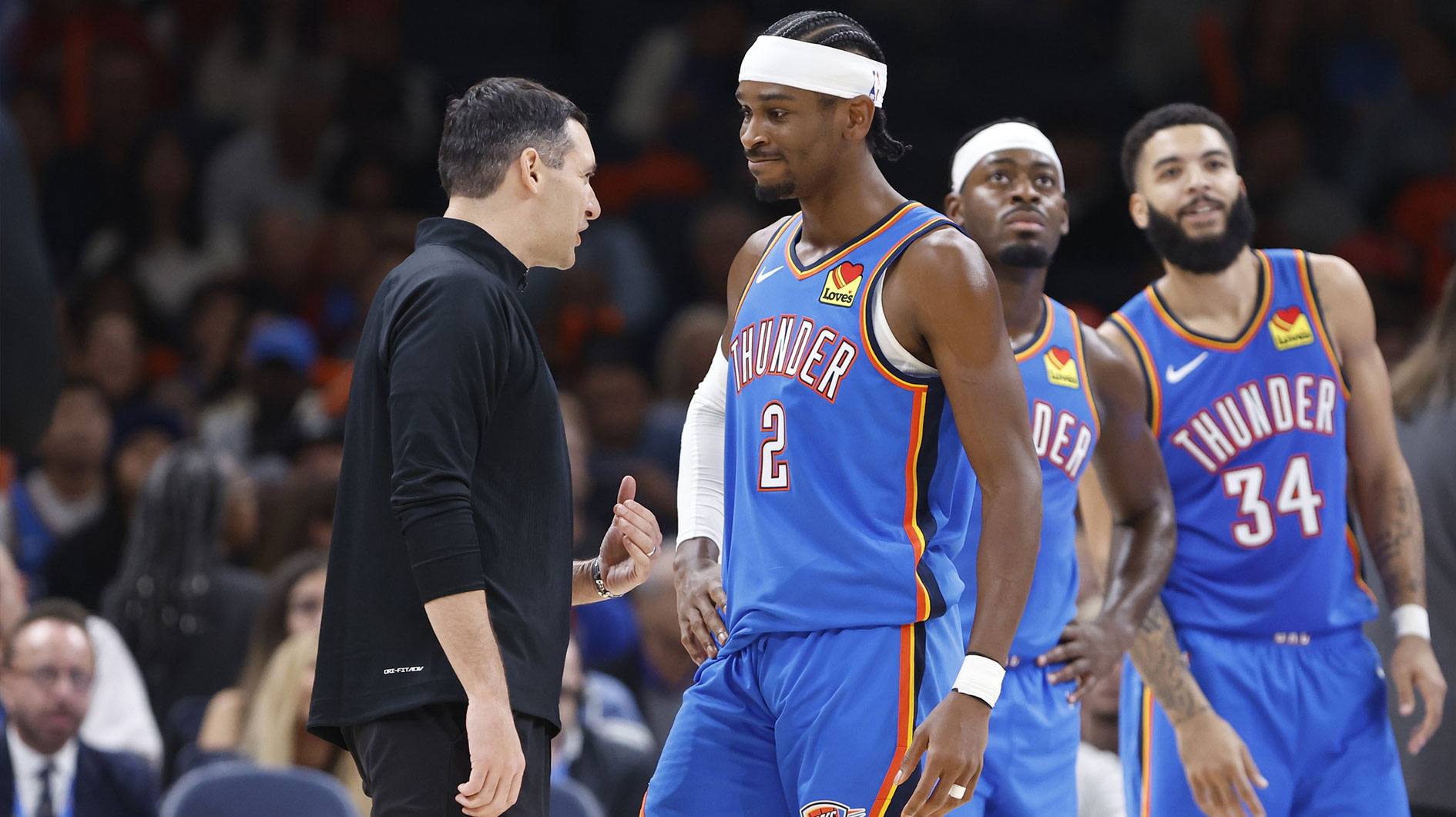 Oklahoma City Thunder guard Shai Gilgeous-Alexander (2) and head coach Mark Daigneault talk during a time out against the New Orleans Pelicans during the second quarter at Paycom Center.