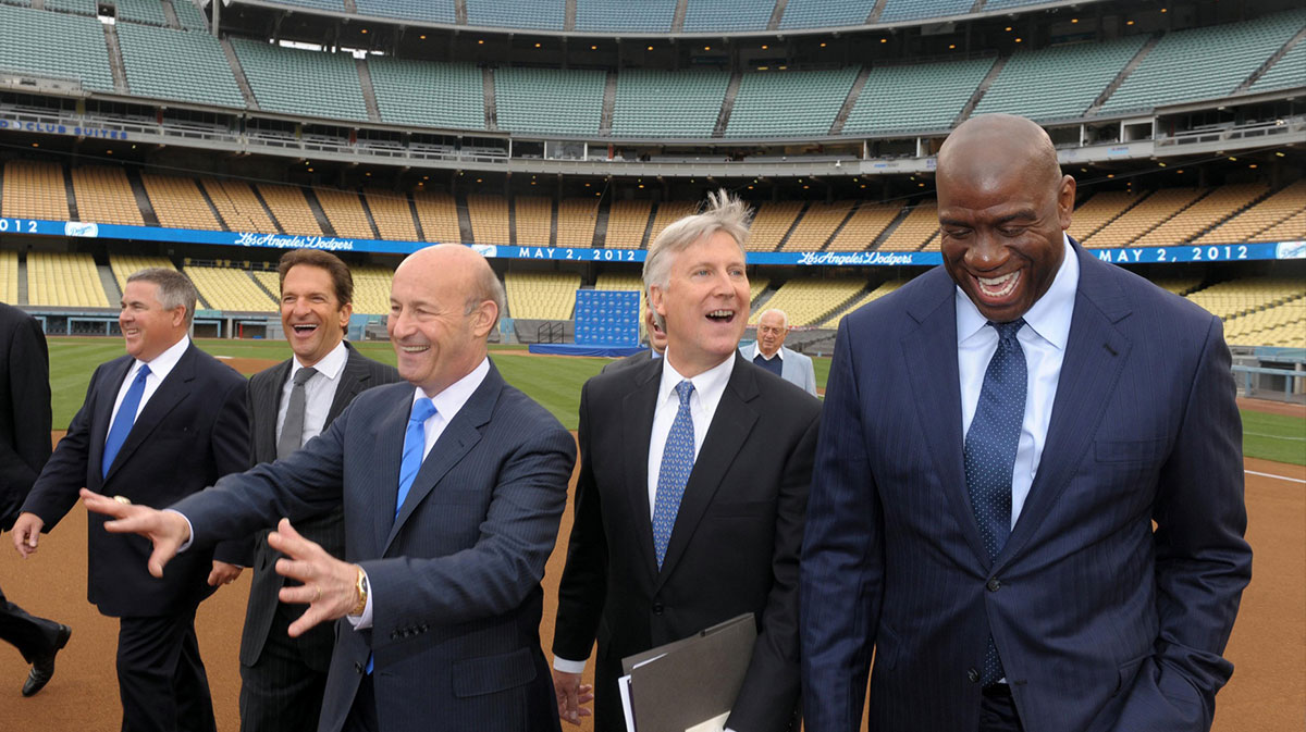 Members of the Guggenheim baseball management team arrive at press conference to announce their purchase of the Los Angeles Dodgers at Dodger Stadium. From left: Bobby Patton and Peter Guber and Stan Kasten and Mark Walter and Magic Johnson.