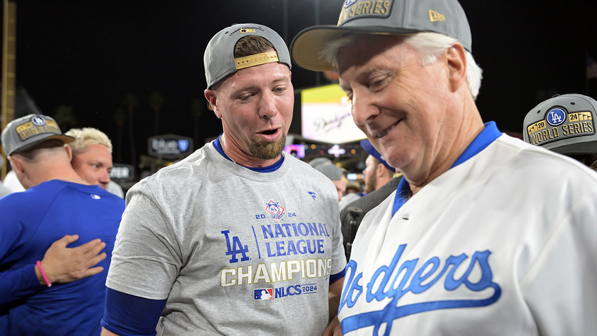 Los Angeles Dodgers pitcher Blake Treinen (49) celebrates with team owner Mark Walter on the field after defeating the New York Mets in game six of the NLCS for the 2024 MLB playoffs to advance to the World Series at Dodger Stadium.