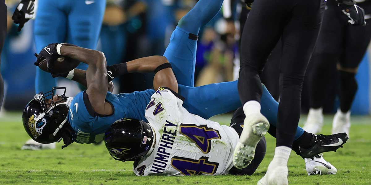 Jacksonville Jaguars wide receiver Calvin Ridley (0) is tackled by Baltimore Ravens cornerback Marlon Humphrey (44) during the fourth quarter of a regular season NFL football matchup.