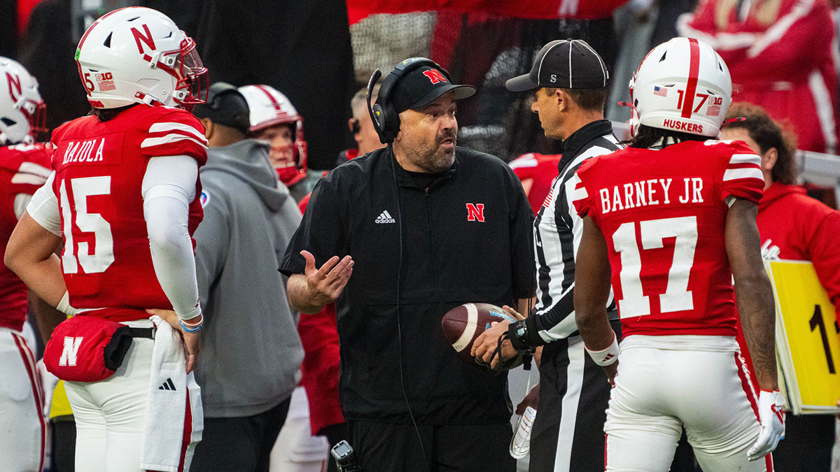 Nebraska Cornhuskers head coach Matt Rhule holds the championship trophy as Cornhuskers players celebrate after the game against the Boston College Eagles at Yankee Stadium.