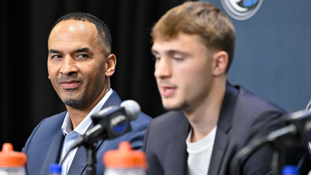 Mavericks general manager Nico Harrison (left) looks on with Mavericks first overall pick Cooper Flagg (right) at a press conference at the Dallas Mavericks Practice Facility