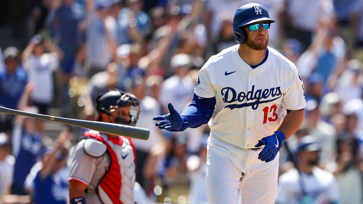 Los Angeles Dodgers third baseman Max Muncy (13) hits a three-run home run during the seventh inning against the Washington Nationals at Dodger Stadium.