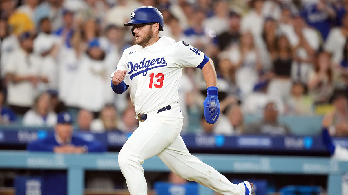 Los Angeles Dodgers third baseman Max Muncy (13) scores in the fifth inning against the San Diego Padres at Dodger Stadium.