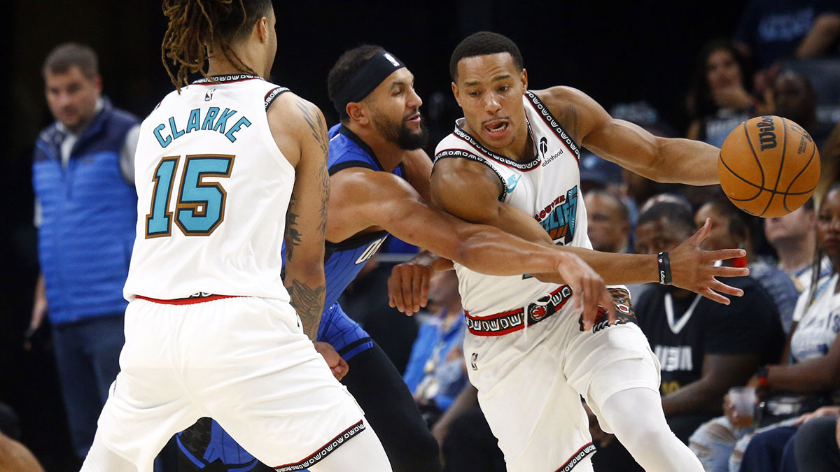 Memphis Grizzlies guard Desmond Bane (22) dribbles around a screen set by forward Brandon Clarke (15) on Orlando Magic guard Jalen Suggs (4) during the first half at FedExForum.