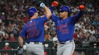 New York Mets outfielder Juan Soto (22) celebrates with first base Pete Alonso (20) after hitting a solo home run against the Arizona Diamondbacks in the sixth inning at Chase Field