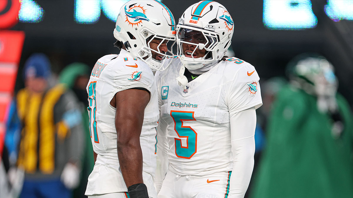 Miami Dolphins cornerback Jalen Ramsey (5) celebrates a defensive stop with linebacker Tyrel Dodson (11) during the first quarter against the New York Jets at MetLife Stadium.