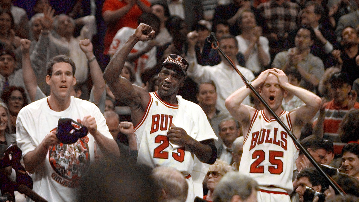 Chicago Bulls players Judd Buechler, left, Michael Jordan, middle, and Steve Kerr celebrate after winning the NBA championship after defeating the Utah Jazz in the 1997 NBA Finals at the United Center.