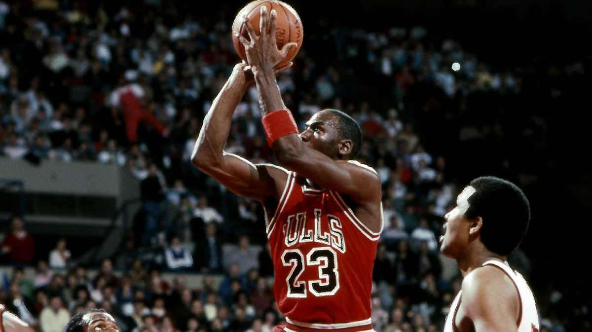 Chicago Bulls guard Michael Jordan (23) shoots the ball between Portland Trailblazers guard Clyde Drexler (22) and Steve Johnson (33) at Memorial Coliseum.