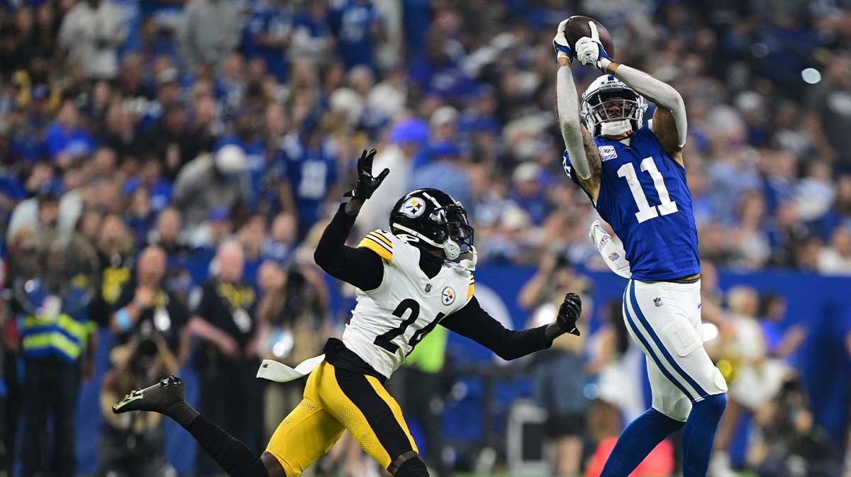 Sep 29, 2024; Indianapolis, Indiana, USA; Indianapolis Colts wide receiver Michael Pittman Jr. (11) catches a pass in front of Pittsburgh Steelers cornerback Joey Porter Jr. (24) during the second quarter at Lucas Oil Stadium.