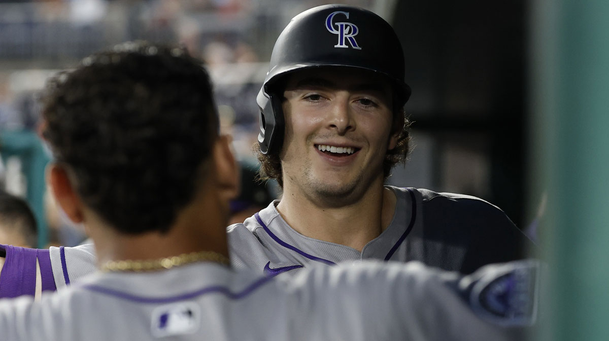 Jun 17, 2025; Washington, District of Columbia, USA; Colorado Rockies first baseman Michael Toglia (4) celebrates with Rockies shortstop Orlando Arcia (11) in the dugout after hitting a solo home run against the Washington Nationals during the seventh inning at Nationals Park. Mandatory Credit: Geoff Burke-Imagn Images