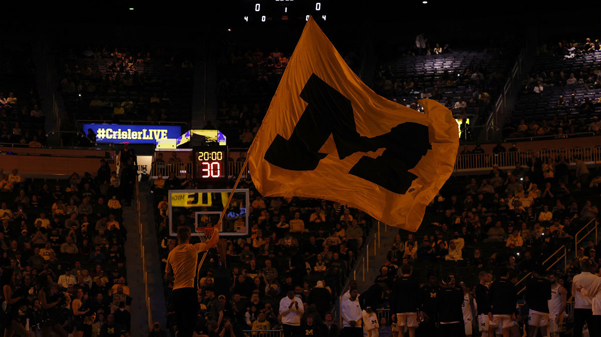 Michigan Wolverines cheerleader wave a flag during player introductions before the game against the Ohio Bobcats at Crisler Center.