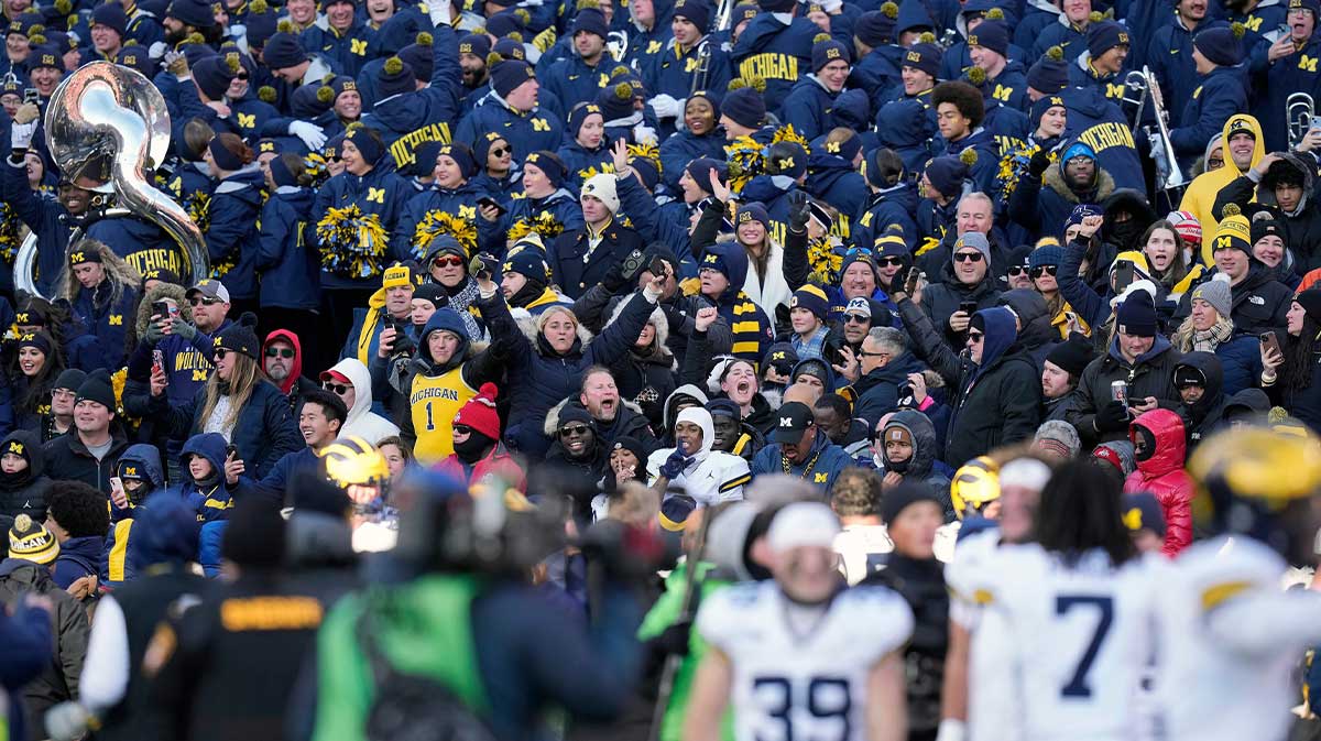 Michigan Wolverines fans celebrate a 13-10 win over Ohio State Buckeyes at the end of the NCAA football game at Ohio Stadium