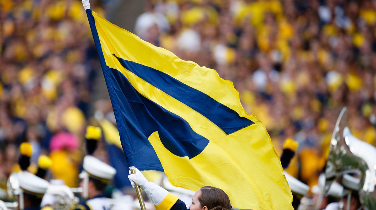 Michigan Wolverines marching band flag bearer prior to the game against the Wisconsin Badgers at Michigan Stadium.