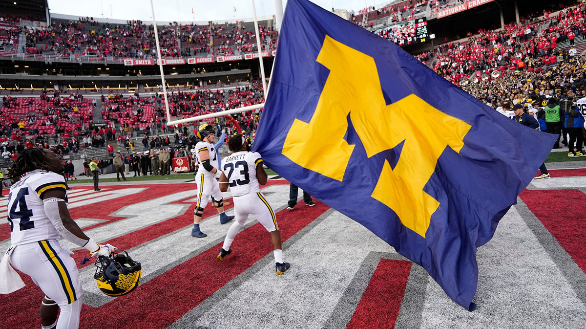 Michigan Wolverines linebacker Michael Barrett (23) waves the Michigan flag following their 45-23 win over the Ohio State Buckeyes in the NCAA football game at Ohio Stadium.