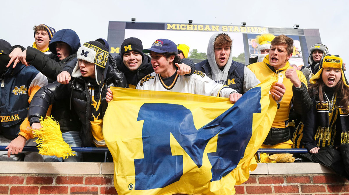 Michigan fans wave a Michigan flag during warmups before the Ohio State game at Michigan Stadium