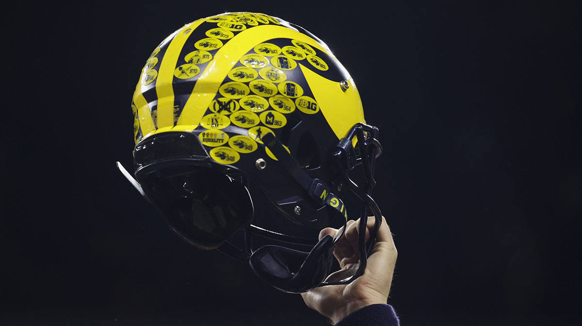 A Michigan Wolverines player holds their helmet following their 43-22 victory against Purdue in the Big Ten Championship at Lucas Oil Stadium.
