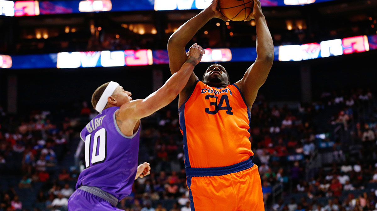 3's Company player Michael Sweetney (34) shoots the ball against Ghost Ballers player Mike Bibby (10) at Spectrum Center.