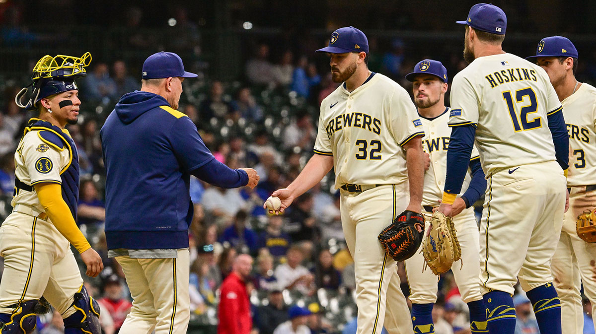 Milwaukee Brewers starting pitcher Aaron Civale (32) hands the ball to manager Pat Murphy during a pitching change in the fifth inning against the Atlanta Braves at American Family Field.