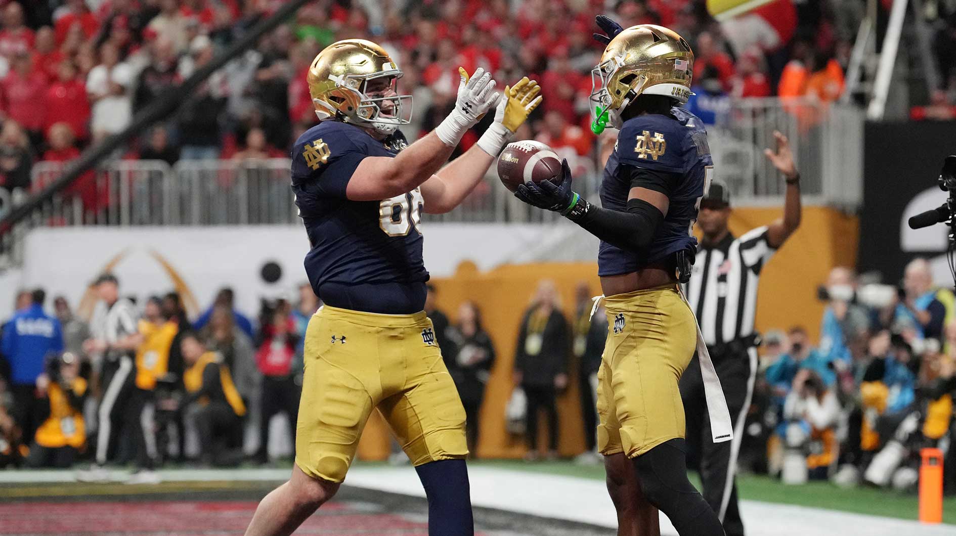 Notre Dame Fighting Irish wide receiver Beaux Collins (5) and Notre Dame Fighting Irish tight end Mitchell Evans (88) celebrate a two-point conversion against the Ohio State Buckeyes in the second half in the CFP National Championship college football game at Mercedes-Benz Stadium.