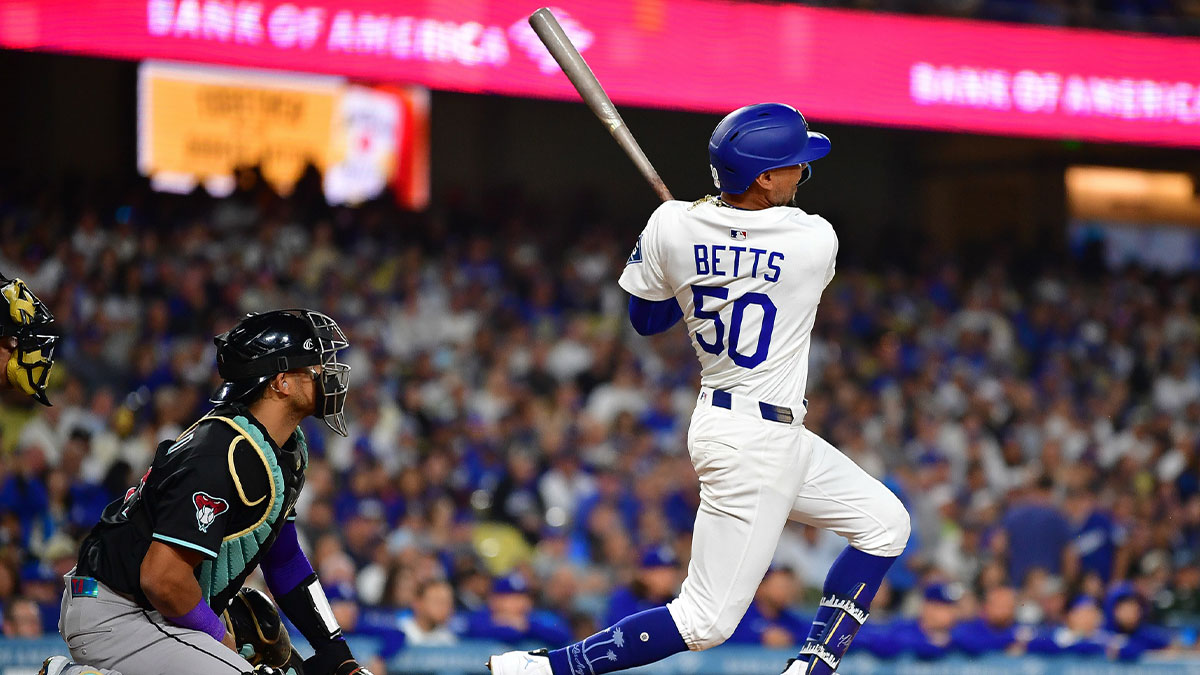 May 19, 2025; Los Angeles, California, USA; Los Angeles Dodgers shortstop Mookie Betts (50) hits a solo home run against the Arizona Diamondbacks during the sixth inning at Dodger Stadium.