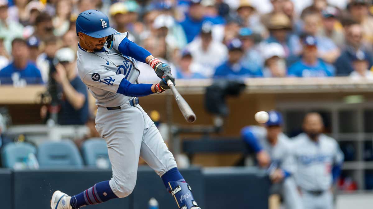 Los Angeles Dodgers shortstop Mookie Betts (50) hits a single during the seventh inning against the San Diego Padres at Petco Park.