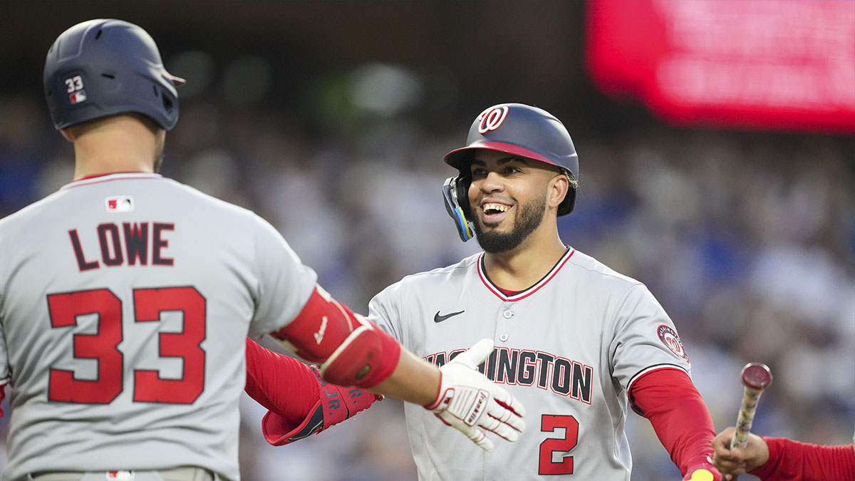 Washington Nationals second base Luis García Jr. (2) celebrates with first base Nathaniel Lowe (33) after scoring a home run in the fourth inning against the Los Angeles Dodgers at Dodger Stadium.