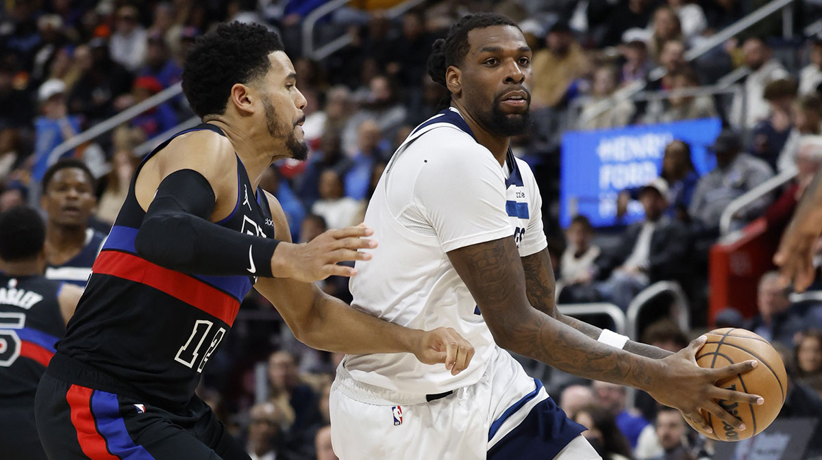 Minnesota Timberwolves center Naz Reid (11) dribbles defended by Detroit Pistons forward Tobias Harris (12) in the second half at Little Caesars Arena.