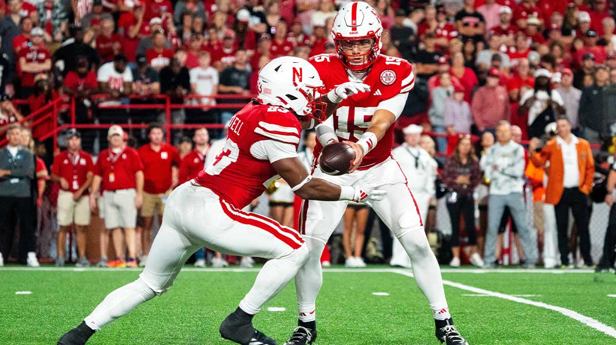 Nebraska Cornhuskers quarterback Dylan Raiola (15) hands the ball off to running back Dante Dowdell (23) during the third quarter against the Colorado Buffaloes at Memorial Stadium.