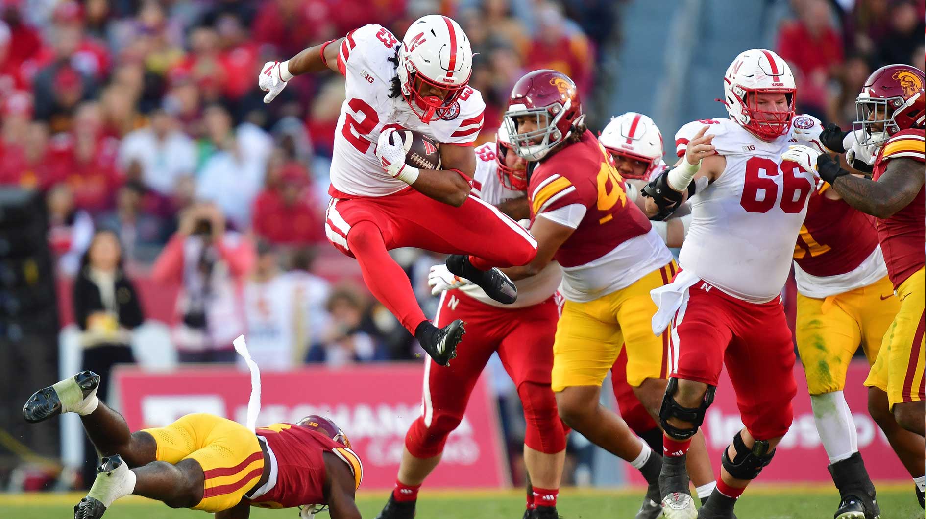 Nebraska Cornhuskers running back Dante Dowdell (23) jumps over Southern California Trojans safety Zion Branch (8) during the second half at the Los Angeles Memorial Coliseum.