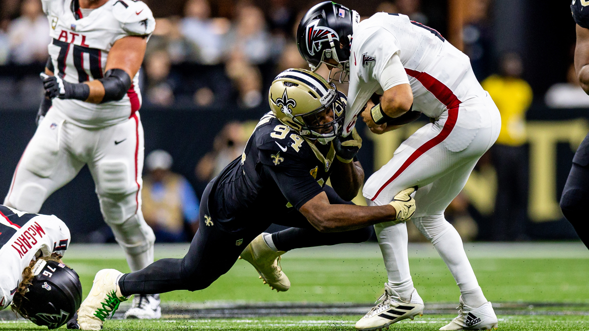 New Orleans Saints defensive end Cameron Jordan (94) leaps over Atlanta Falcons defensive end Khalid Kareem (92) to sack Atlanta Falcons quarterback Kirk Cousins (18) during the second half at Caesars Superdome.