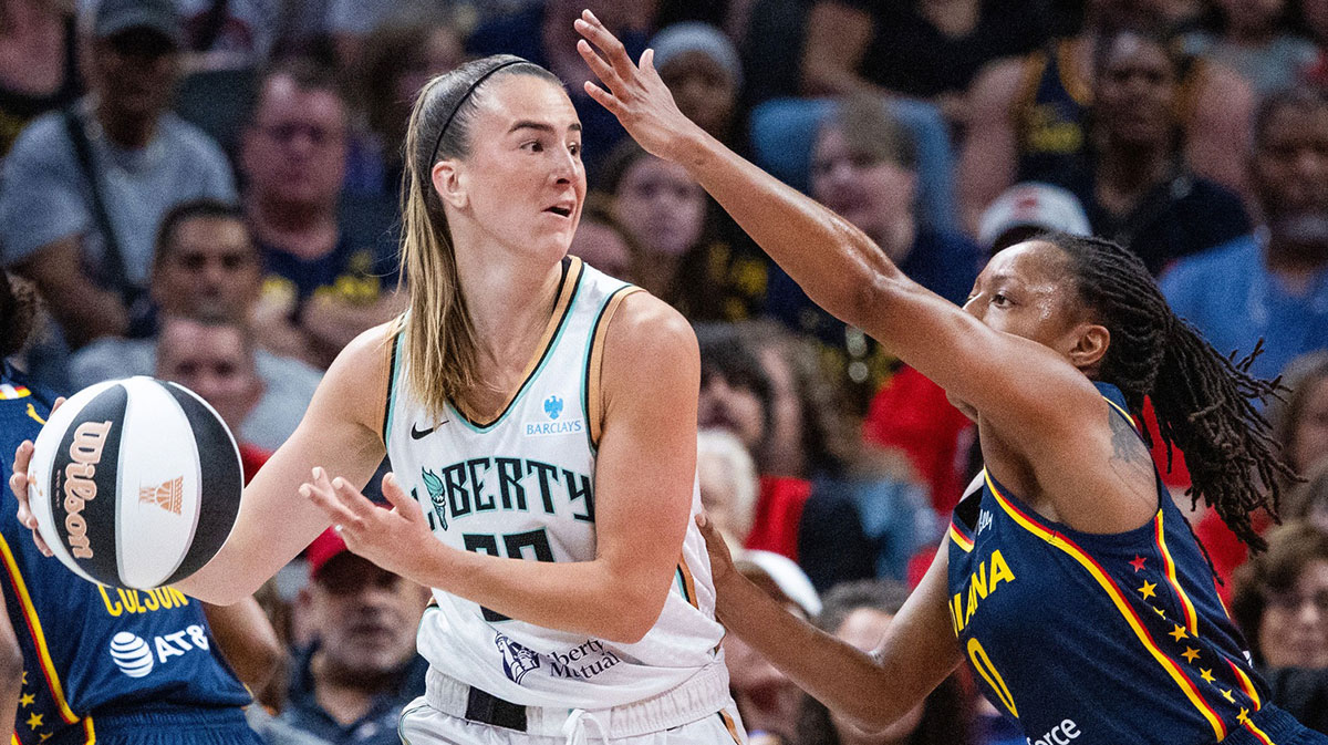 New York Liberty guard Sabrina Ionescu (20) dribbles the ball while Indiana Fever guard Kelsey Mitchell (0) defends in the first half at Gainbridge Fieldhouse.