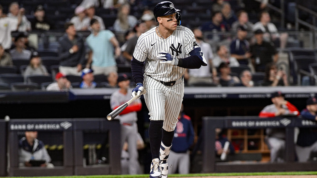 New York Yankees outfielder Aaron Judge (99) hits a two-run home run against the Boston Red Sox during the ninth inning at Yankee Stadium.