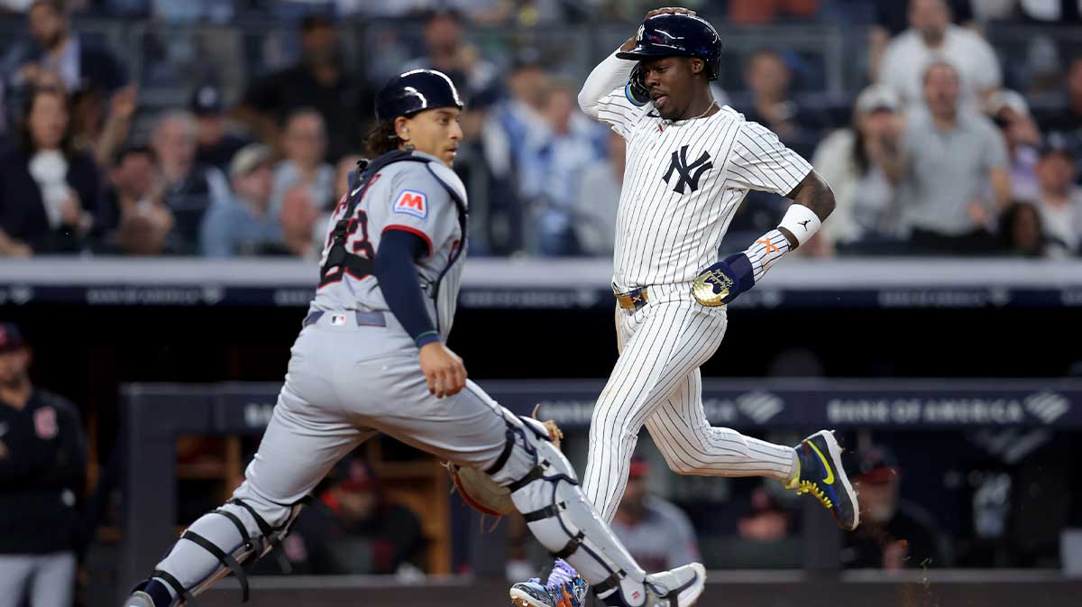 New York Yankees third baseman Jazz Chisholm Jr. (13) scores a run against Cleveland Guardians catcher Bo Naylor (23) on a single by Yankees second baseman DJ LeMahieu (not pictured) during the fifth inning at Yankee Stadium. Aaron Boone Anthony Volpe