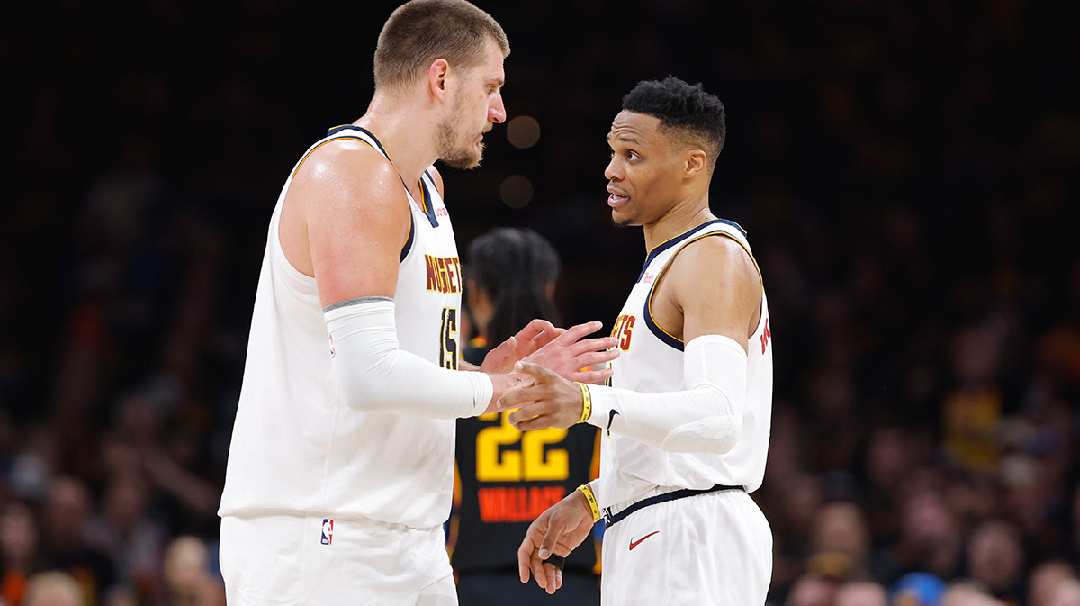Denver Nuggets center Nikola Jokic (15) and guard Russell Westbrook (4) talk a break in play against the Oklahoma City Thunder during the second half during game one of the second round for the 2025 NBA Playoffs at Paycom Center. 