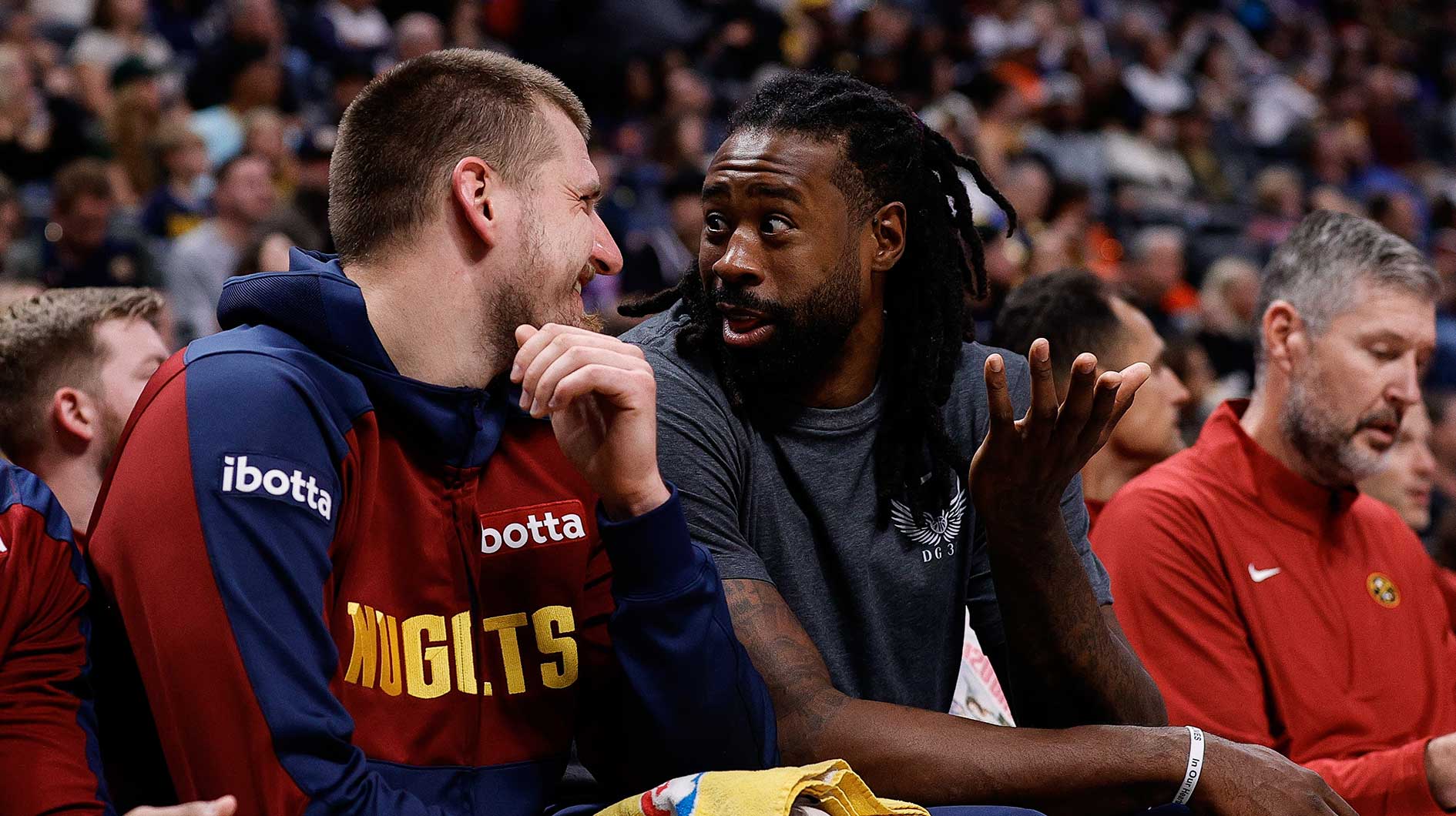 Denver Nuggets center Nikola Jokic (15) and center DeAndre Jordan (6) talk on the bench in the second quarter against the Phoenix Suns at Ball Arena.