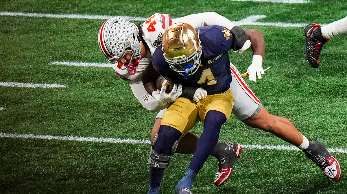 Ohio State Buckeyes defensive end JT Tuimoloau (44) tackles Notre Dame Fighting Irish running back Jeremiyah Love (4) during the College Football Playoff championship at Mercedes-Benz Stadium in Atlanta on Jan. 20, 2025.