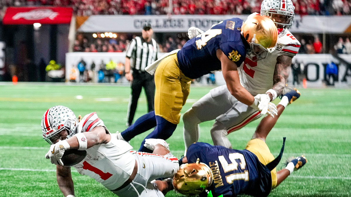 Ohio State Buckeyes running back Quinshon Judkins (1) scores a rushing touchdown against Notre Dame Fighting Irish cornerback Leonard Moore (15) in the second quarter during the College Football Playoff National Championship at Mercedes-Benz Stadium in Atlanta on January 20, 2025.