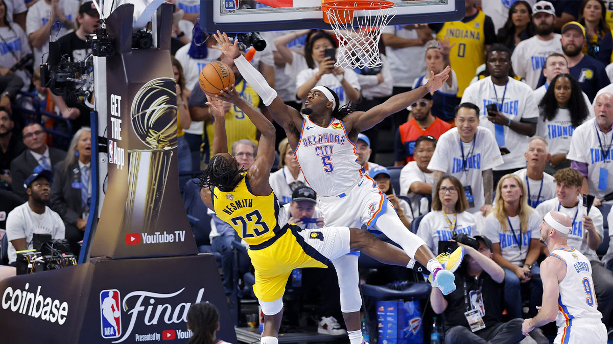 Oklahoma City Thunder guard Luguentz Dort (5) blocks a shot by Indiana Pacers forward Aaron Nesmith (23) during the fourth quarter during game one of the 2025 NBA Finals at Paycom Center.