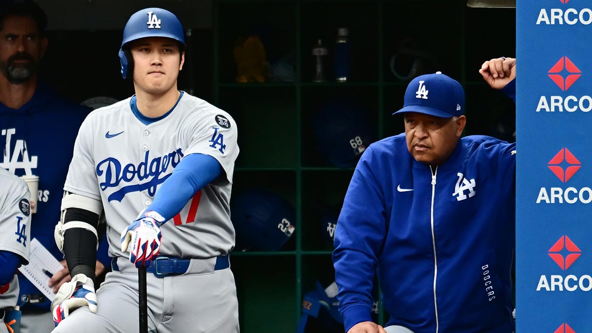 Los Angeles Dodgers designated hitter Shohei Ohtani (17) waits next to manager Dave Roberts (30) for his turn to bat during the ninth inning against the Cleveland Guardians at Progressive Field.