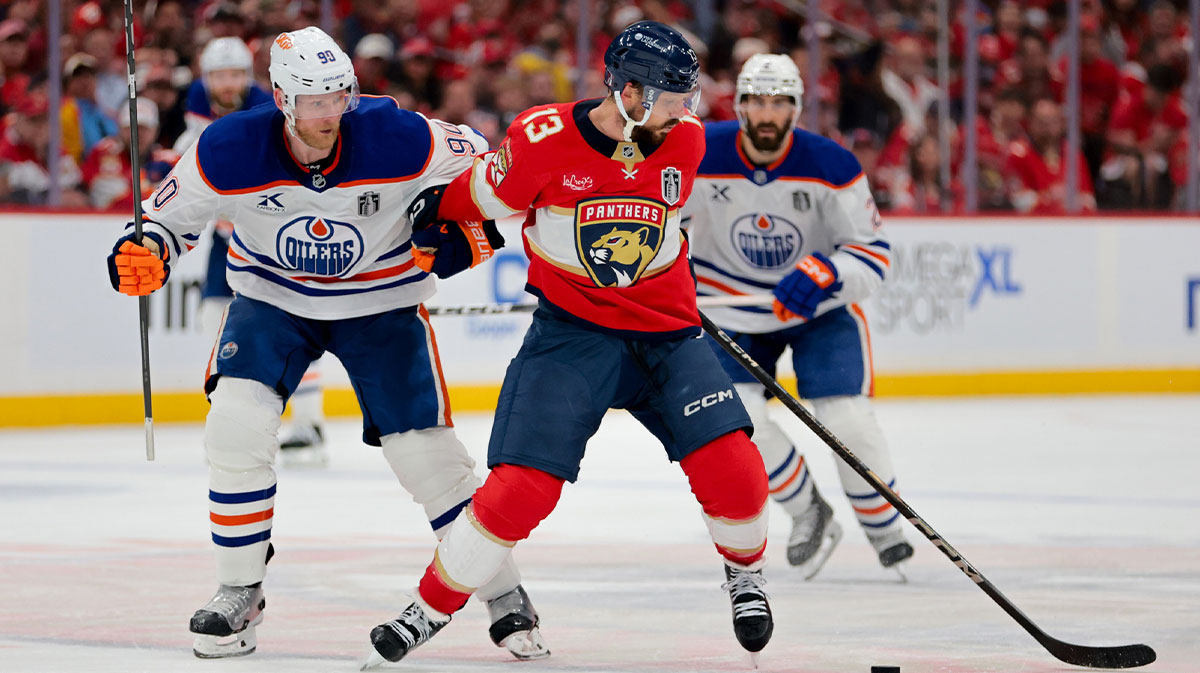 Florida Panthers center Sam Reinhart (13) controls the puck defended by Edmonton Oilers right wing Corey Perry (90) during the second period in game six of the 2025 Stanley Cup Final at Amerant Bank Arena.