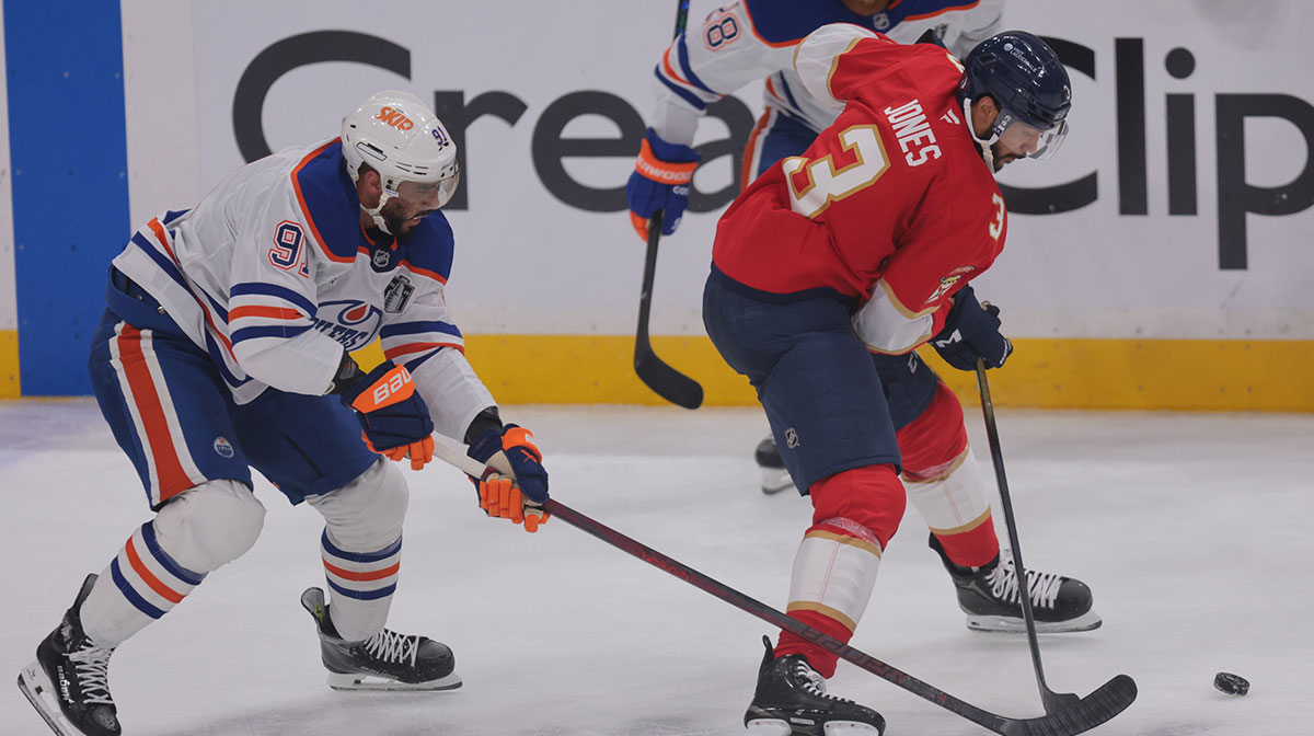 Florida Panthers defenseman Seth Jones (3) carries the puck against Edmonton Oilers left wing Evander Kane (91) during the second period in game three of the 2025 Stanley Cup Final at Amerant Bank Arena.