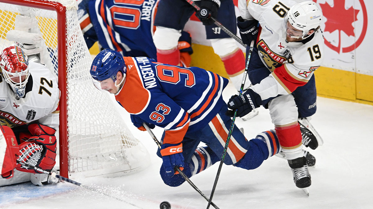 Edmonton Oilers center Ryan Nugent-Hopkins (93) and Florida Panthers left wing Matthew Tkachuk (19) attempt to get a loose puck during the second period in game one of the 2025 Stanley Cup Final at Rogers Place.